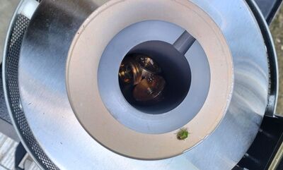 The crucible and furnace arrangement ready for use, with the workshop set up before heat is introduced
