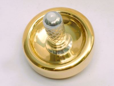 Cairnspire brass spinning top studio portrait